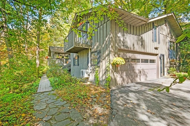 view of property exterior featuring a balcony and a garage