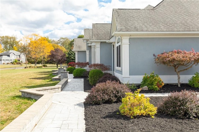 view of side of home with a lawn