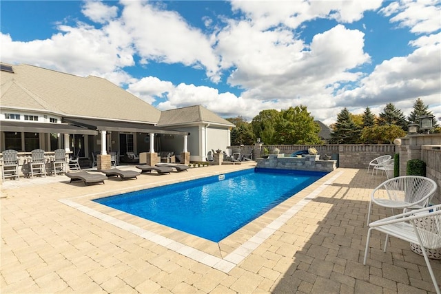 view of swimming pool with a patio area and a hot tub