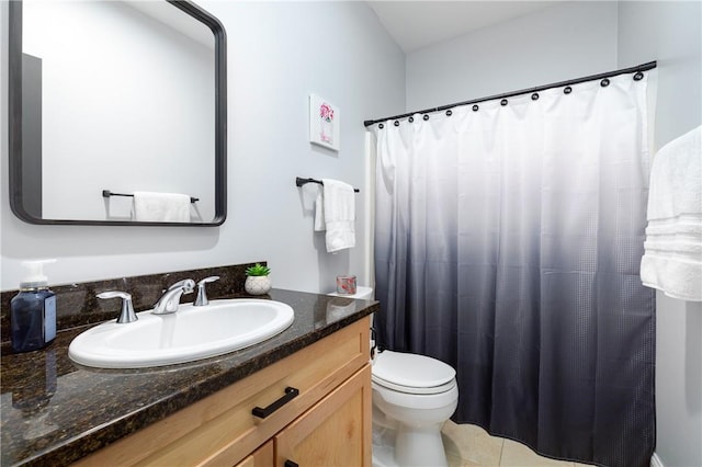 bathroom featuring tile patterned floors, vanity, and toilet