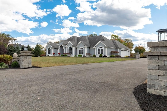 view of front of home featuring a garage and a front lawn