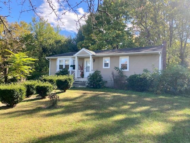 ranch-style home with a front lawn