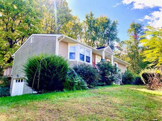 view of side of property with a yard