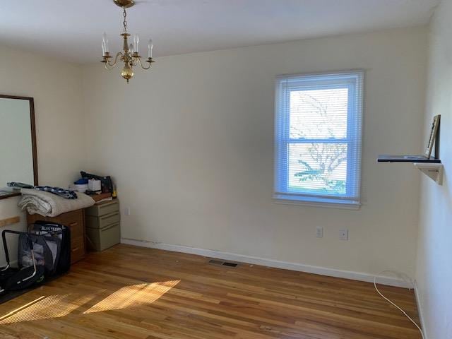 interior space featuring a chandelier and hardwood / wood-style flooring