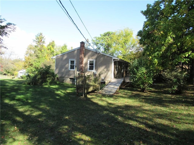 back of house featuring a yard and a wooden deck