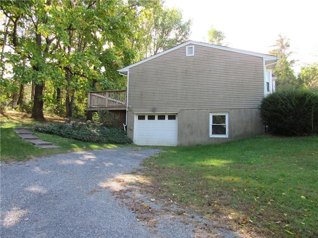 view of home's exterior featuring a lawn, a garage, and a wooden deck