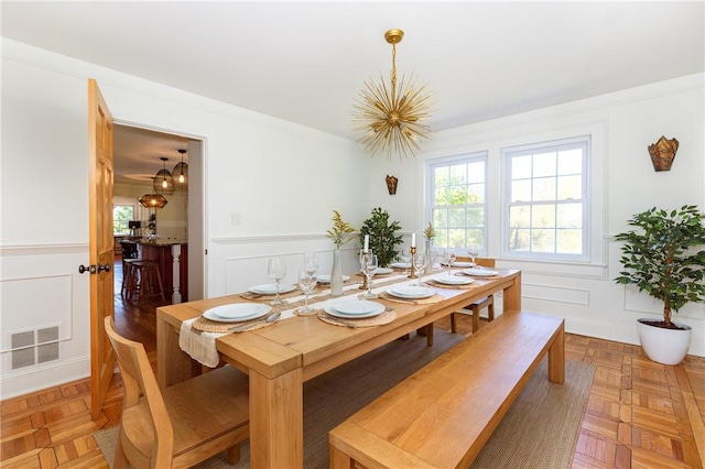 dining room featuring parquet flooring and ornamental molding