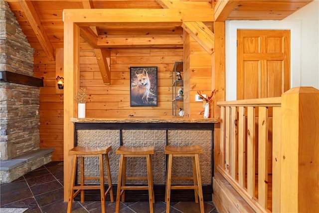 bar featuring wooden walls, wood ceiling, and vaulted ceiling