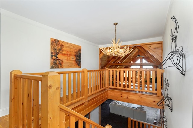 staircase with a chandelier