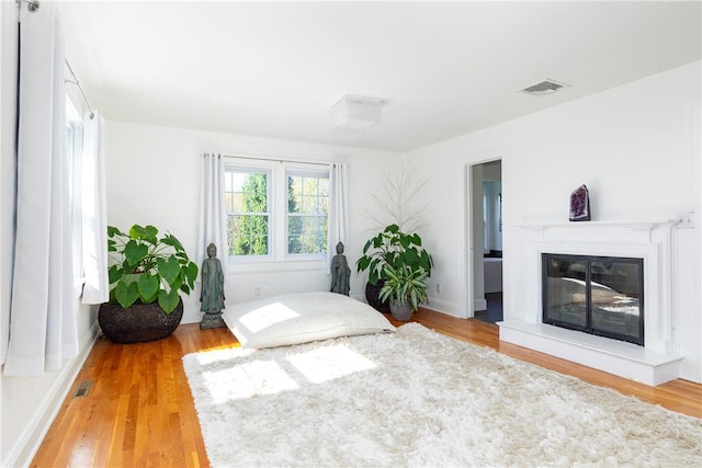 bedroom with hardwood / wood-style flooring and ensuite bath