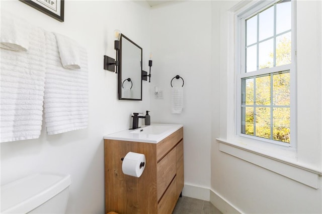 bathroom featuring tile patterned flooring, vanity, and toilet