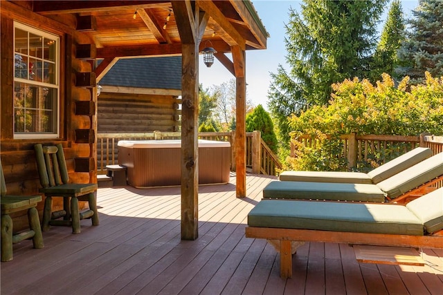 wooden deck with a hot tub