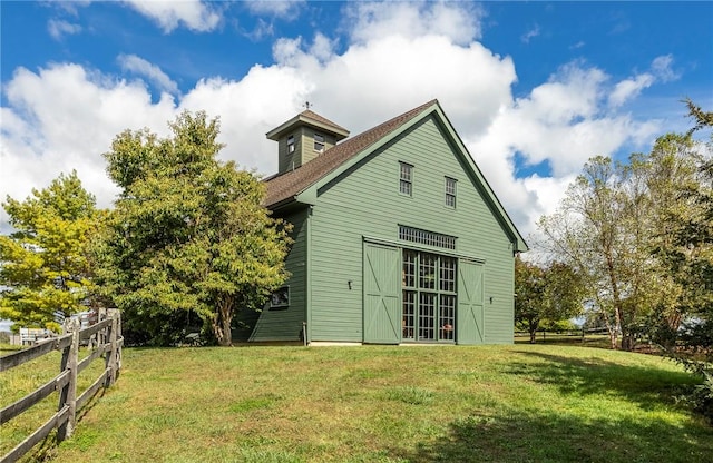 rear view of property featuring a yard