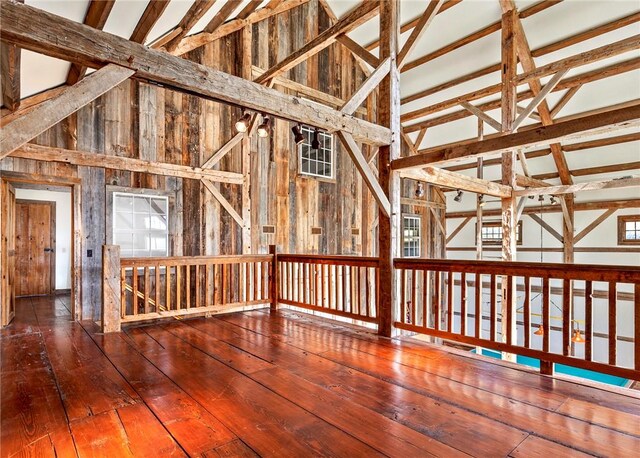 interior space with beamed ceiling, wood-type flooring, and high vaulted ceiling