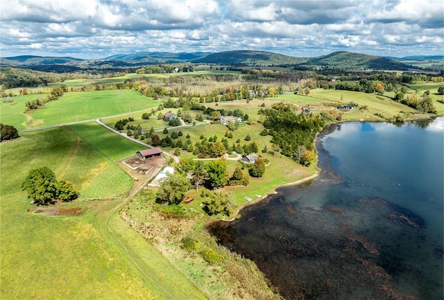 drone / aerial view featuring a rural view and a water and mountain view