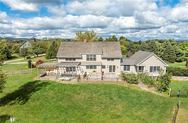 rear view of property with a patio area and a yard