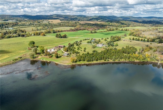 birds eye view of property with a water and mountain view and a rural view