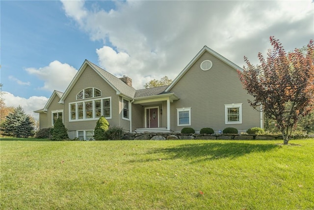 rear view of property with a lawn