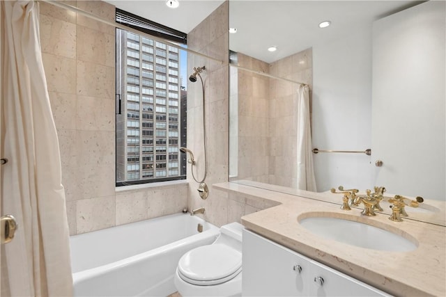 full bathroom featuring vanity, toilet, and shower / tub combo