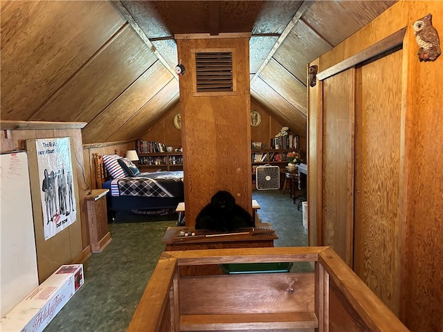 carpeted bedroom with vaulted ceiling, wood ceiling, and wooden walls