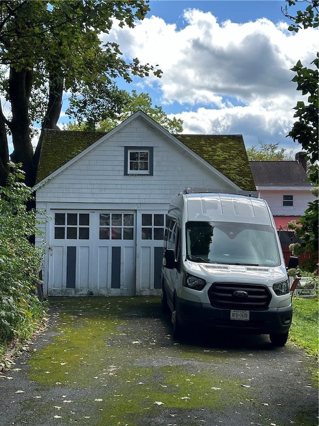 71 High St, Monticello, NY 12701 - view of front facade with driveway and an outdoor structure