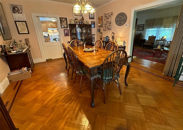 dining area featuring parquet flooring, crown molding, and a chandelier