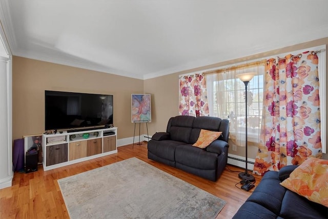 living room with light wood-type flooring, ornamental molding, and a baseboard radiator