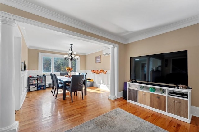 dining space with light wood-type flooring, crown molding, a wall mounted AC, and a chandelier