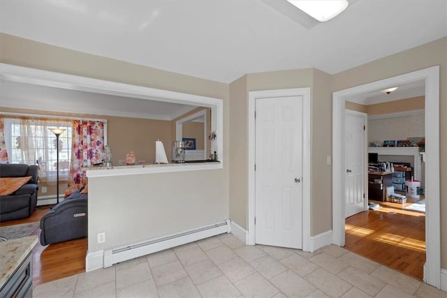 interior space with light hardwood / wood-style floors and a baseboard heating unit