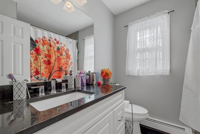 bathroom featuring vanity, a baseboard radiator, toilet, and ceiling fan