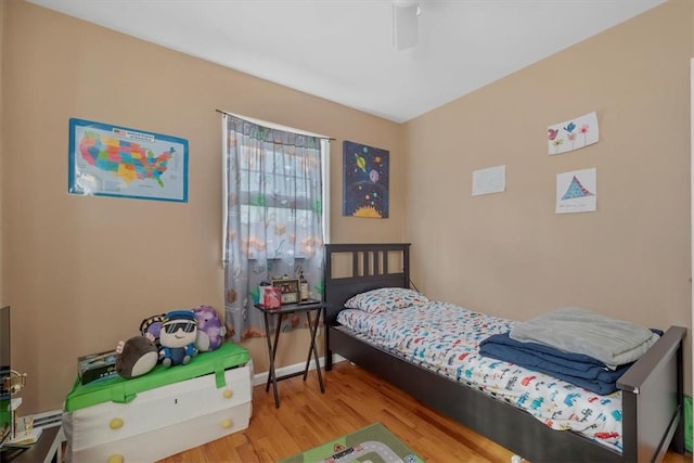 bedroom with hardwood / wood-style floors and ceiling fan