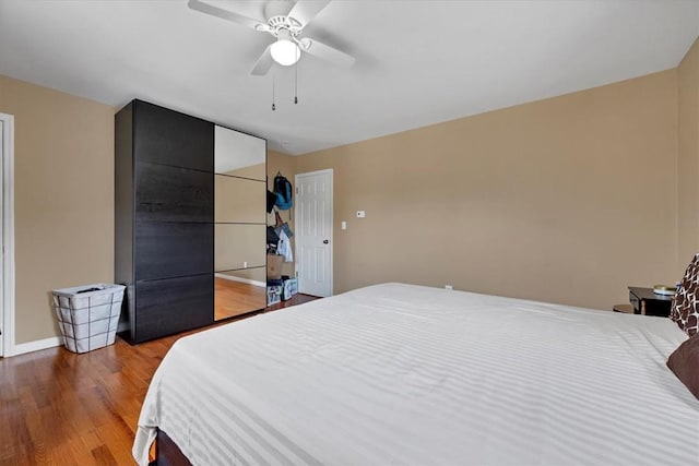 bedroom featuring ceiling fan and hardwood / wood-style flooring