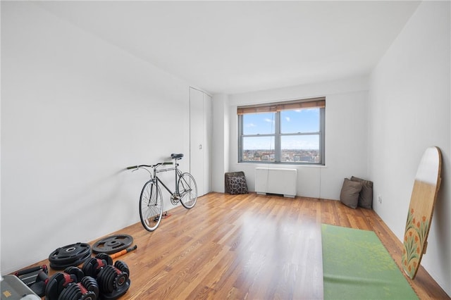 interior space with radiator heating unit and hardwood / wood-style floors