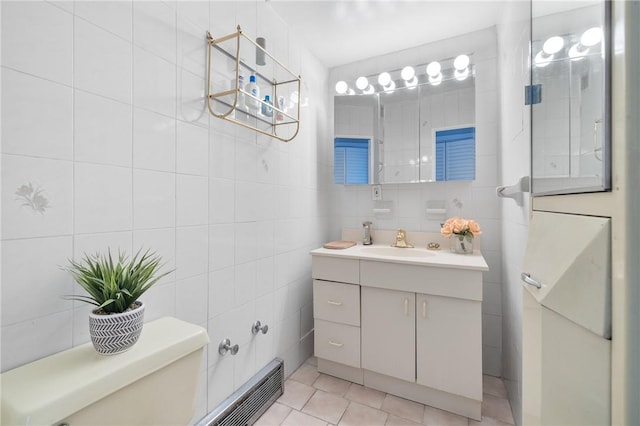 bathroom featuring tile patterned flooring and tile walls