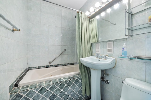 full bathroom featuring sink, toilet, tile walls, and shower / tub combo with curtain