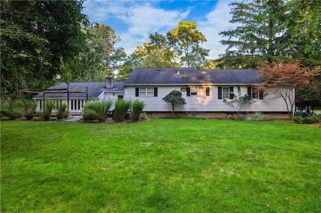 back of house with a lawn