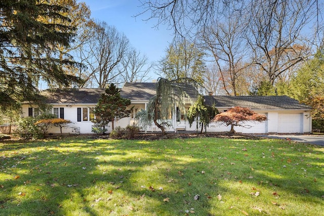 ranch-style house with a garage and a front lawn