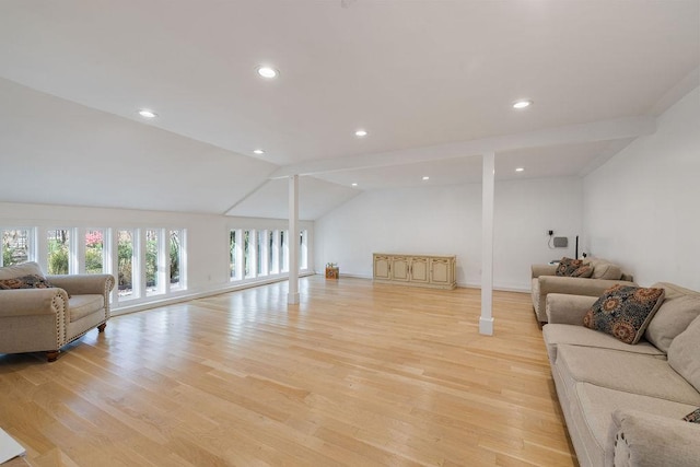 living room with light hardwood / wood-style flooring and vaulted ceiling