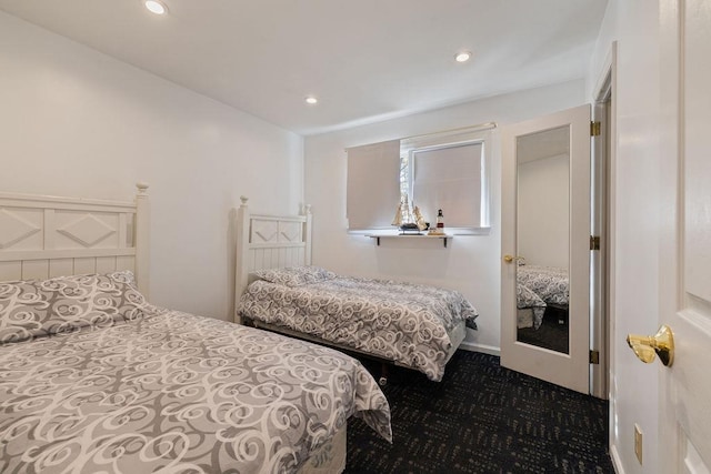 bedroom with dark colored carpet