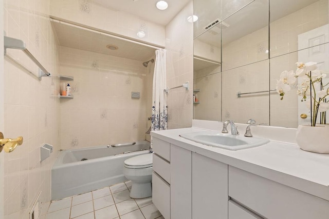 full bathroom featuring tile patterned flooring, shower / bath combination with curtain, tile walls, and vanity