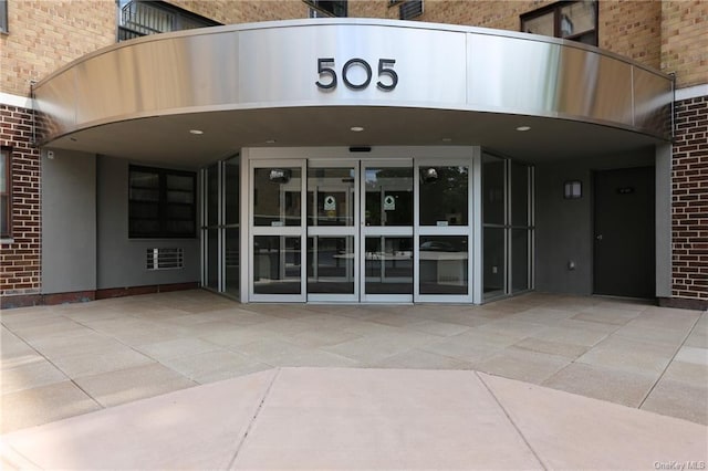 entrance to property featuring a patio