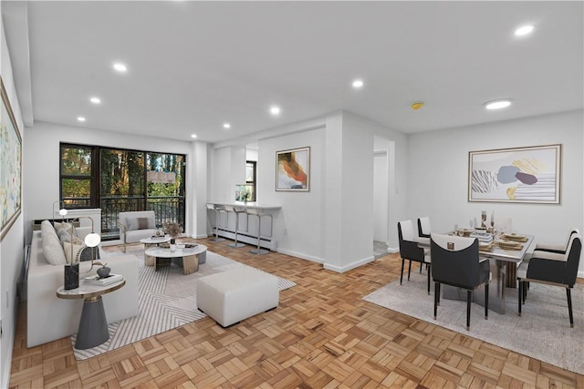 living room featuring a baseboard radiator and light parquet floors