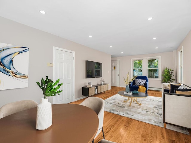 living room with light hardwood / wood-style floors and baseboard heating