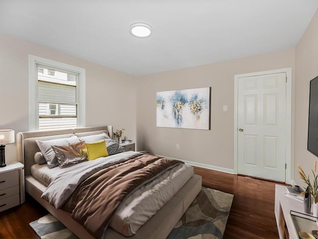 bedroom with dark hardwood / wood-style floors