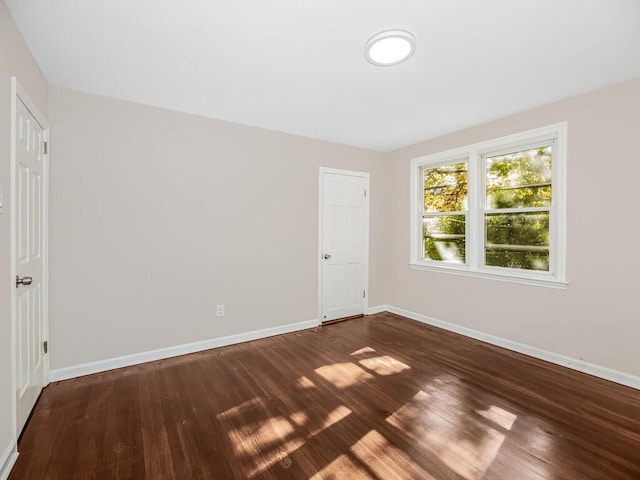 spare room with wood-type flooring