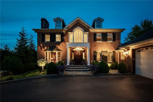 colonial inspired home with a garage