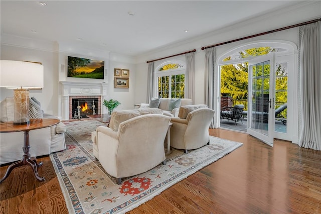 living room with hardwood / wood-style floors, crown molding, and french doors