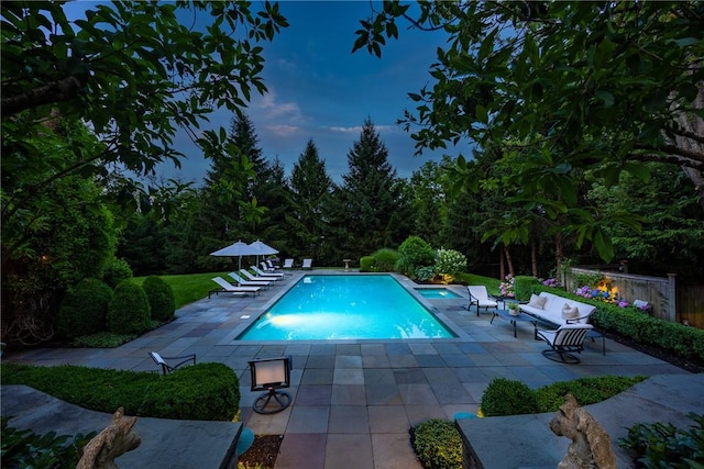 view of pool with an outdoor living space and a patio