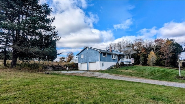 view of home's exterior featuring a lawn and a garage