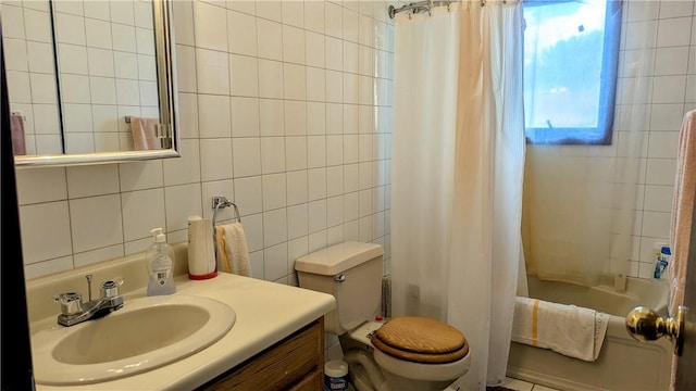 full bathroom featuring vanity, toilet, shower / bath combo with shower curtain, and tile walls